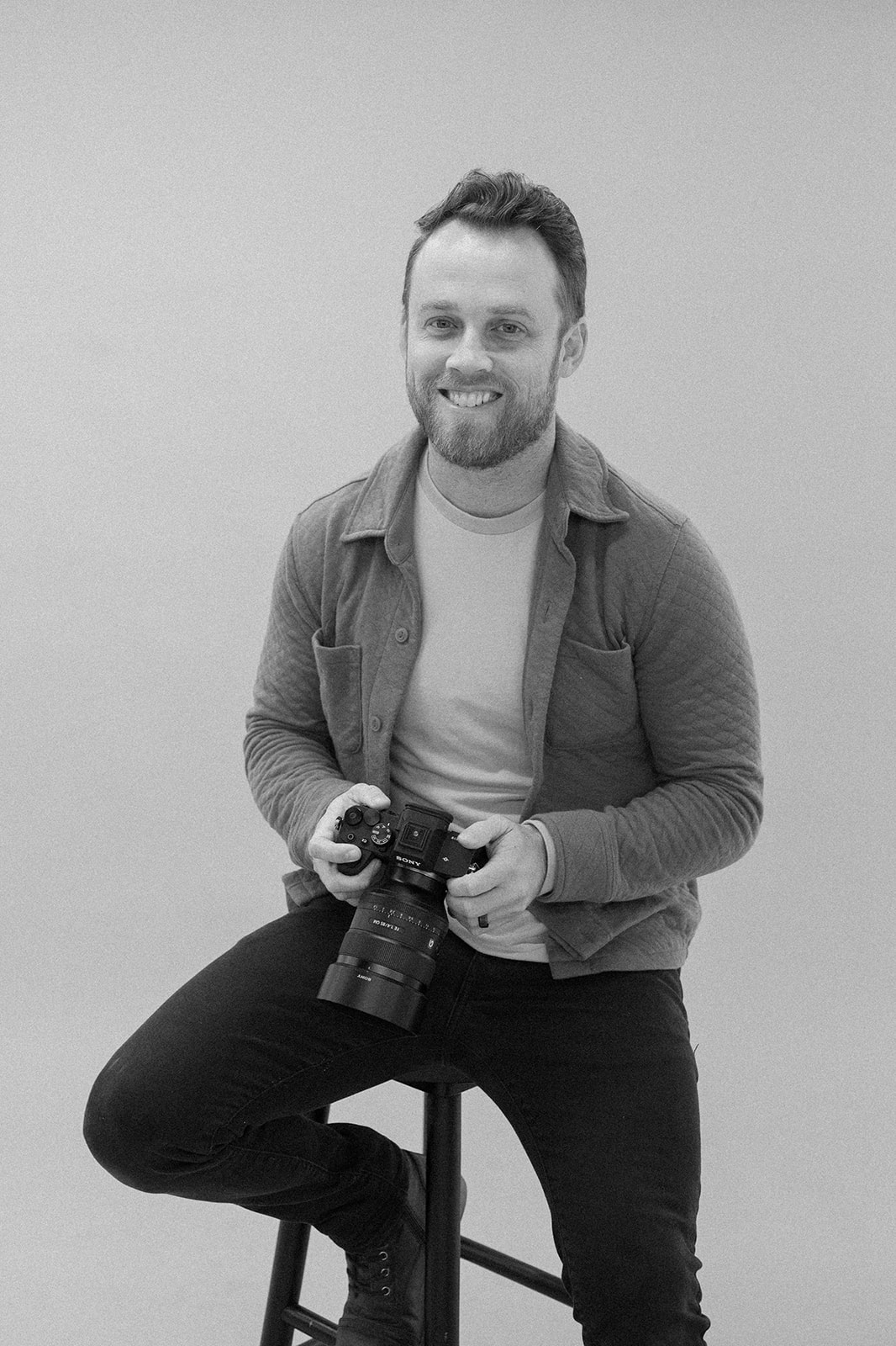 Ryan Abbott, founder of Cuely and a working California wedding photographer, holding his camera